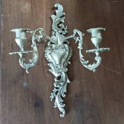 Cast iron wall candle holder with patinated gold metal