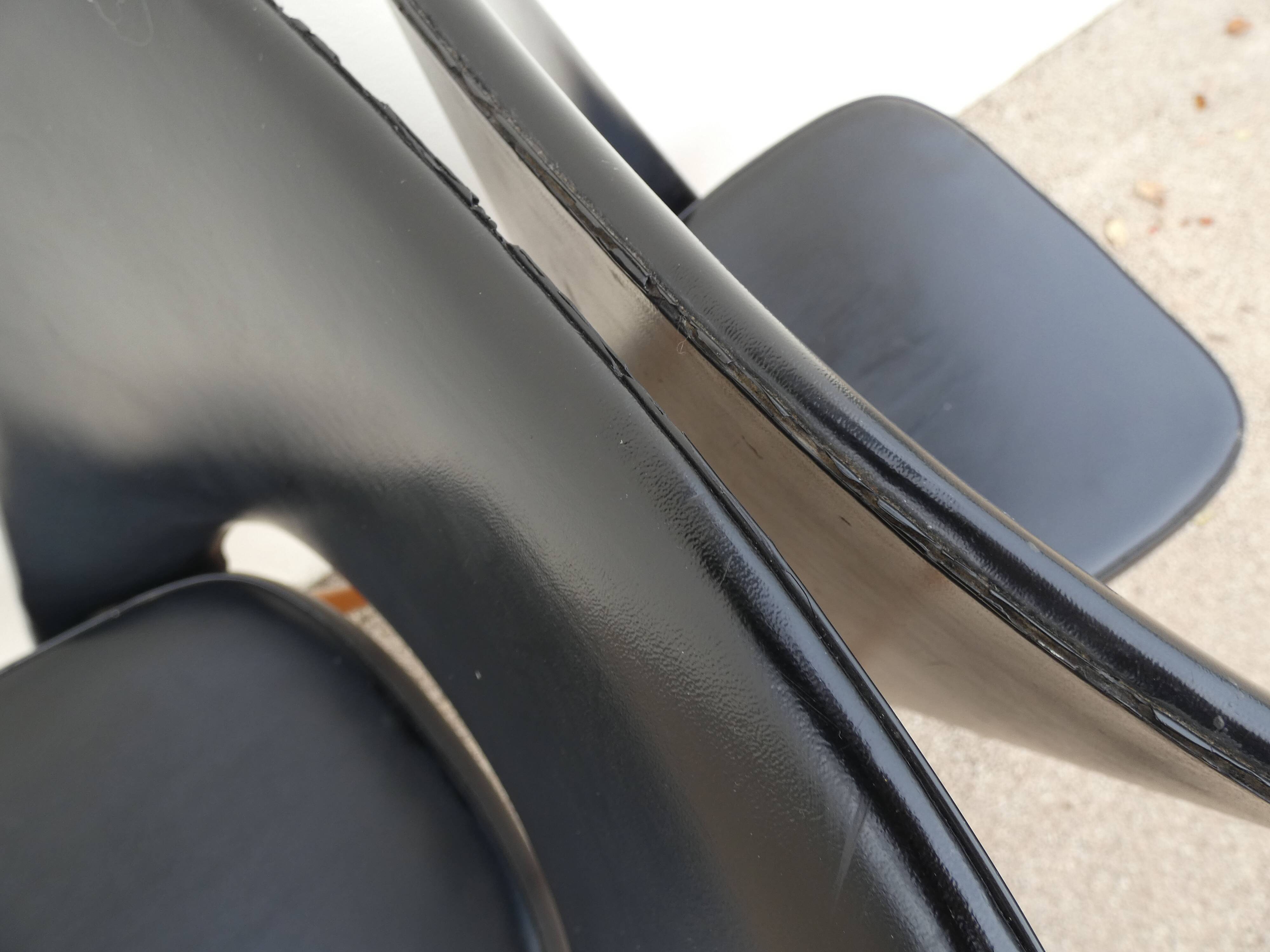 2 chairs in black skai compass legs Louis Paolozzi