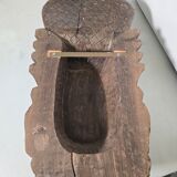 Ancient Indian carved wooden mask sculpture of a deity with a cobra.