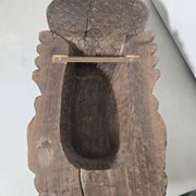 Ancient Indian carved wooden mask sculpture of a deity with a cobra.