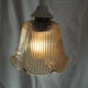 Suspension in a ribbed tulip shape, made of smoked glass.