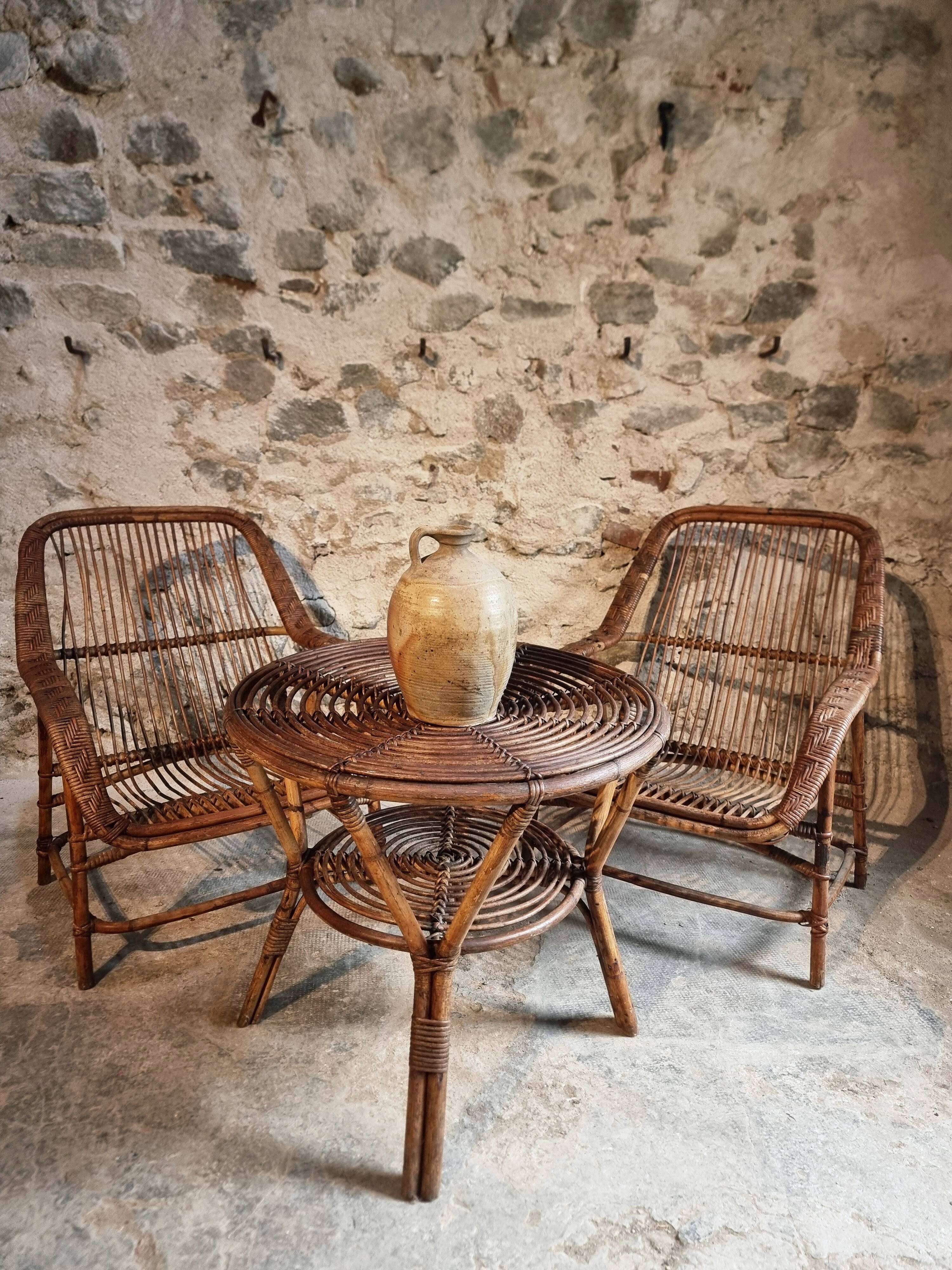 Vintage rattan lounge set, French wicker armchairs and round table, circa 1930–1950.