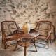 Vintage rattan lounge set, French wicker armchairs and round table, circa 1930–1950.