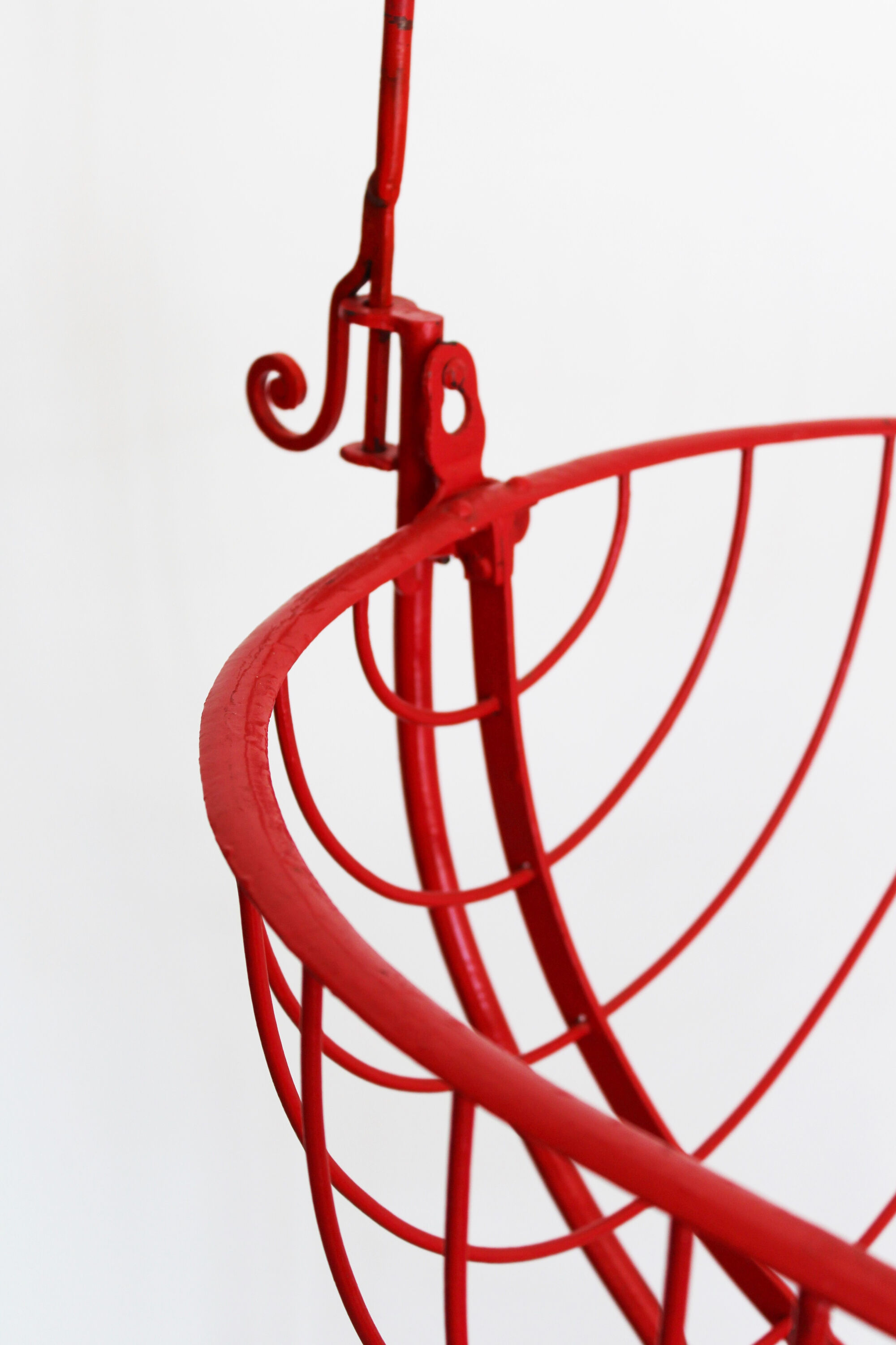 Baby cradle in red wrought iron