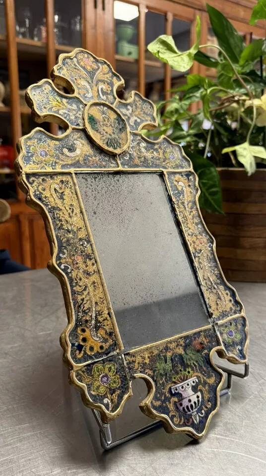 Eglomise glass mirror with scrollwork and branch races decoration