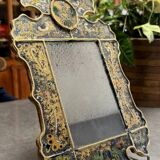 Eglomise glass mirror with scrollwork and branch races decoration