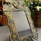 Eglomise glass mirror with scrollwork and branch races decoration