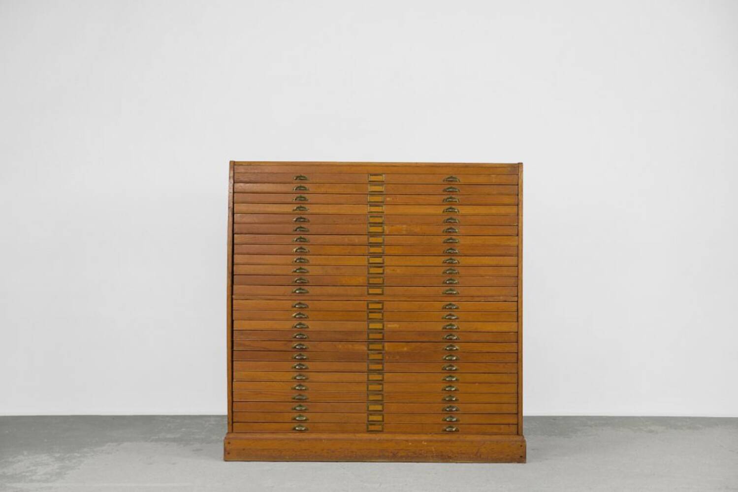 Vintage industrial oak filing cabinet with several drawers, 1930s.