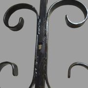 Pair of wrought iron candlesticks with cast bronze ball, 1970s.