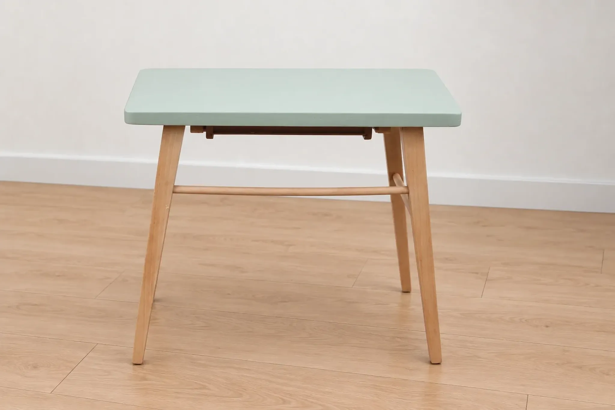 Small vintage children's desk attributed to Baumann – natural wood and lizard green top.