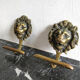 Pair of brass lion head patères