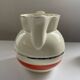 Red, white and silver porcelain jug set by Edmond Bellefroid for Robo.