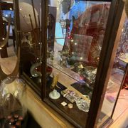Dark-stained wood and glass vintage display cabinet — early 20th-century wall-mounted showcase