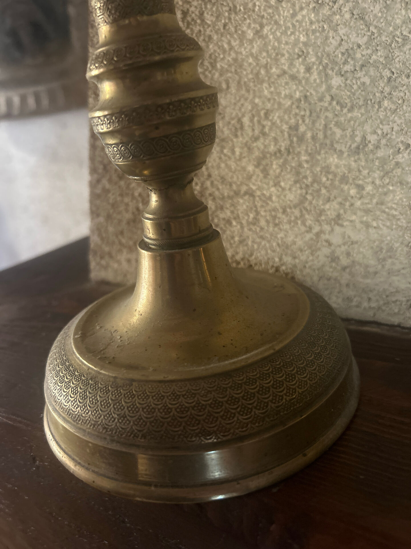Large antique brass candlestick with floral decoration.