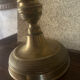 Large antique brass candlestick with floral decoration.
