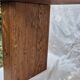 Brutalist wooden bench made of solid oak beam.