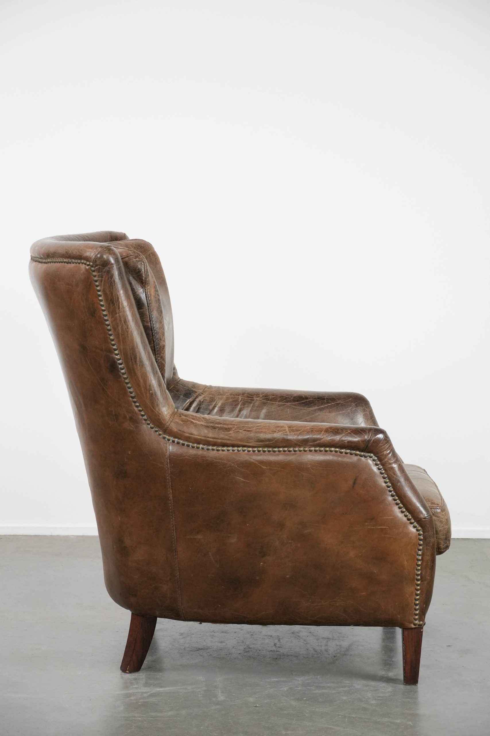 Very comfortable vintage cow leather armchair with character