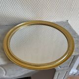 Round mirror with golden wood frame