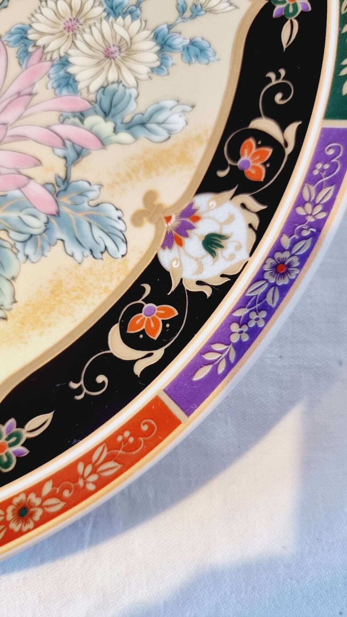 Vintage Japanese decorative plate with chrysanthemum and bird patterns.