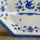 Antique octagonal plate in blue and white pottery with bird decoration.