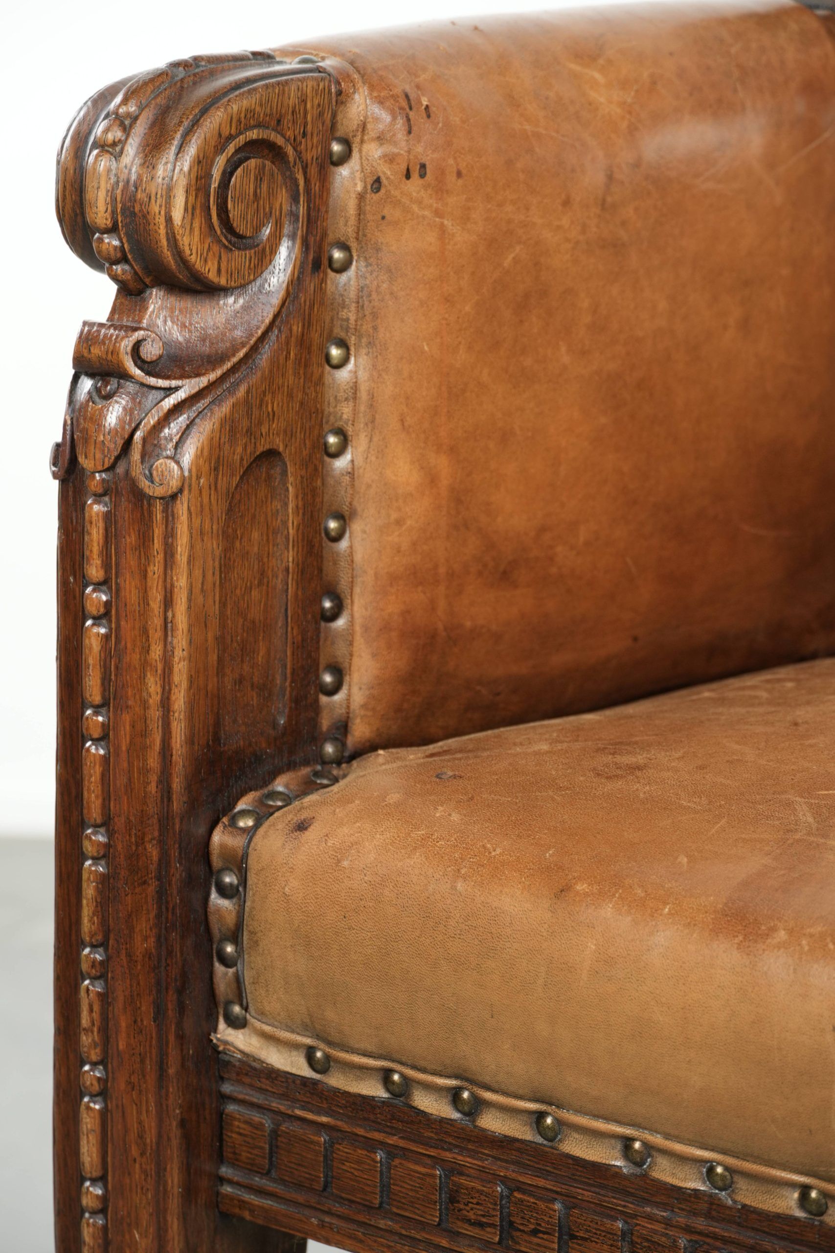 Antique armchair made of sheepskin and wood with decorative nails