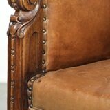 Antique armchair made of sheepskin and wood with decorative nails