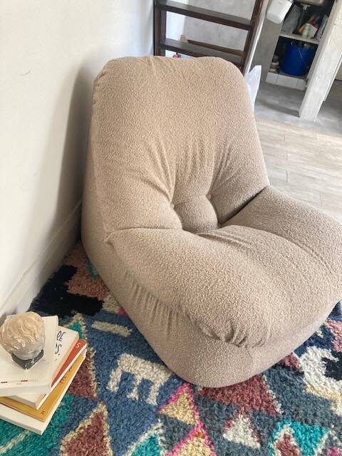 Vintage armchair reupholstered in boucle fabric.