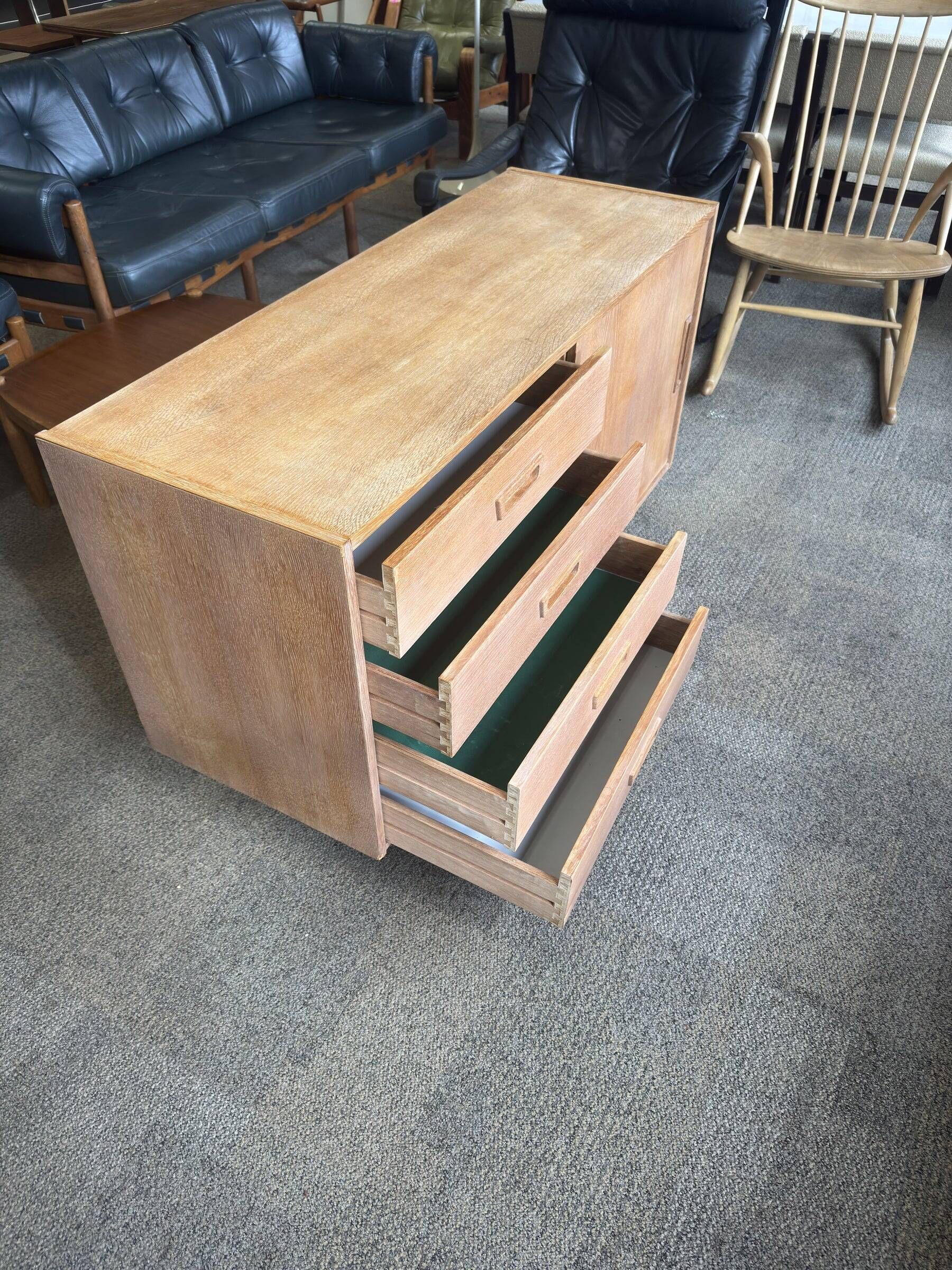 Danish buffet in light oak with sliding door and four drawers.