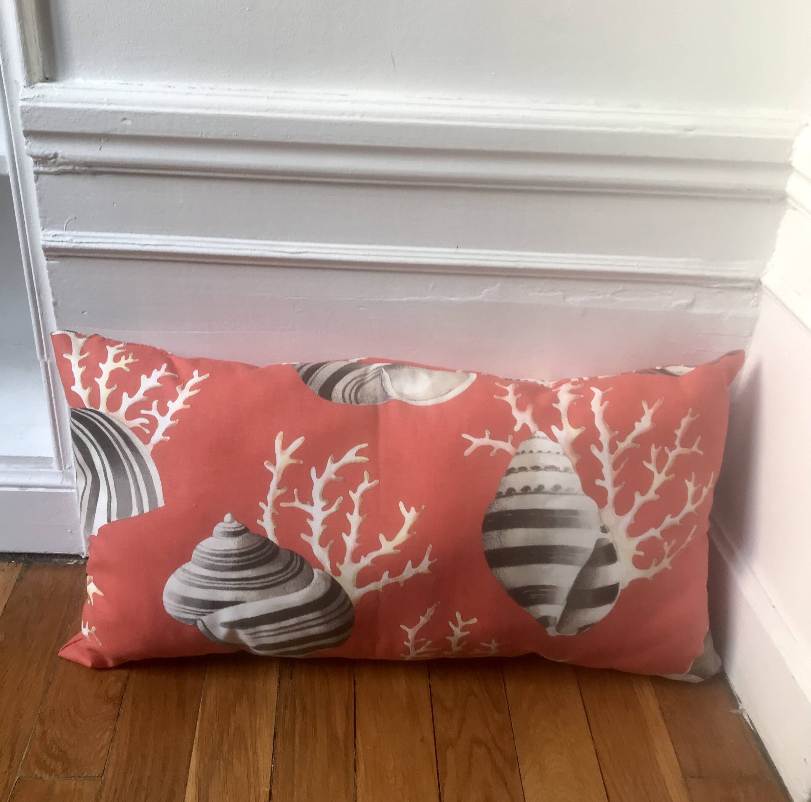Coral and shell cushion