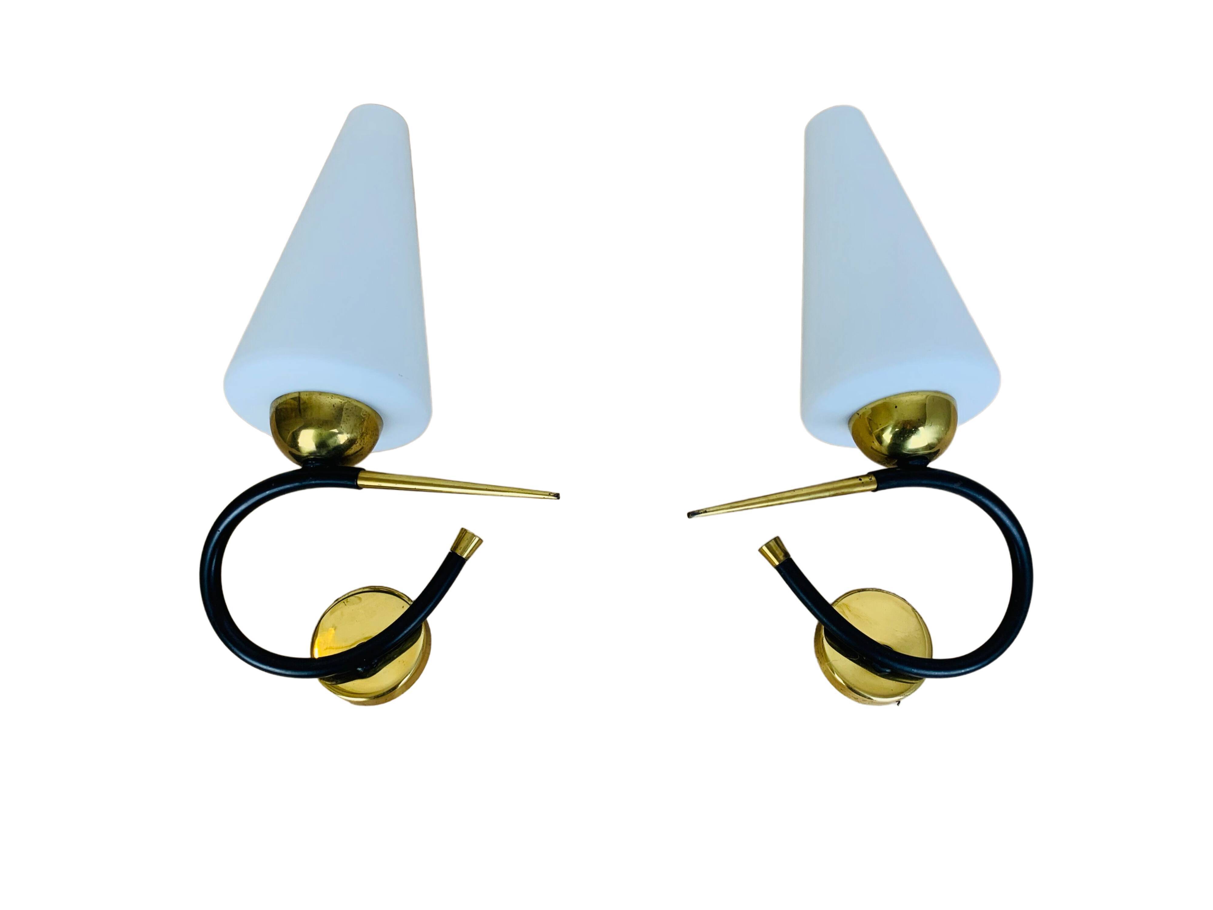 Pair of Arlus 50s opaline black and golden brass wall lamps