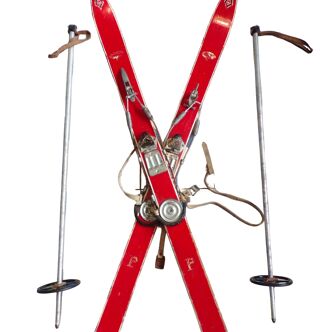 Pair of vintage children's skis with poles