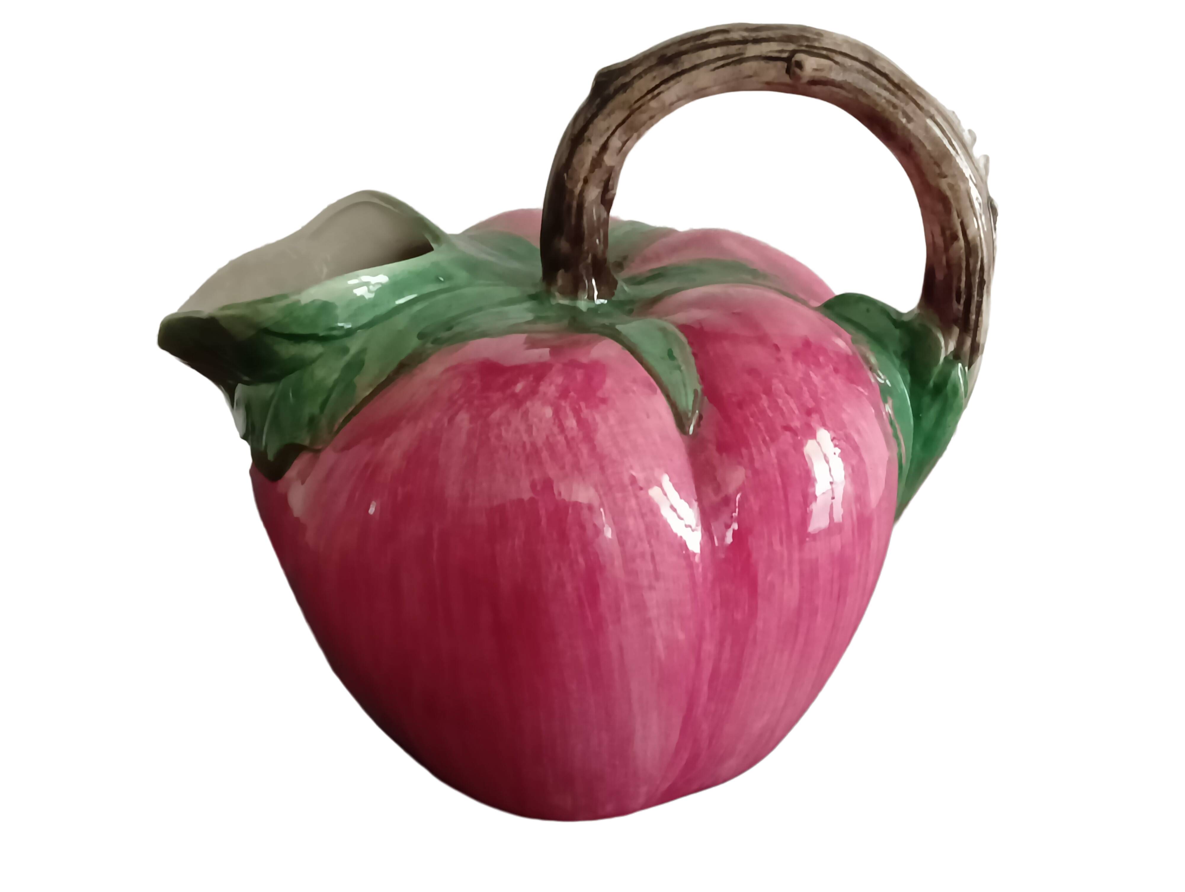 Pink pitcher in the shape of a strawberry, Italian slurry.