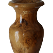 Artisanal turned olive wood vase with varnish.
