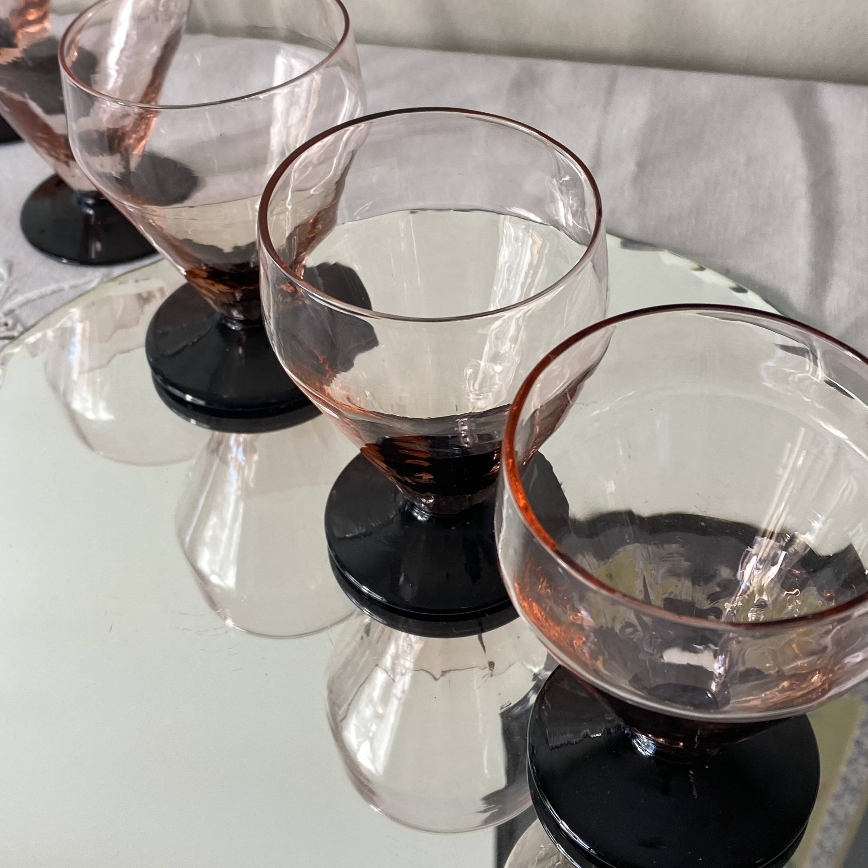 6 small Art Deco pink wine or water glasses with black stems.