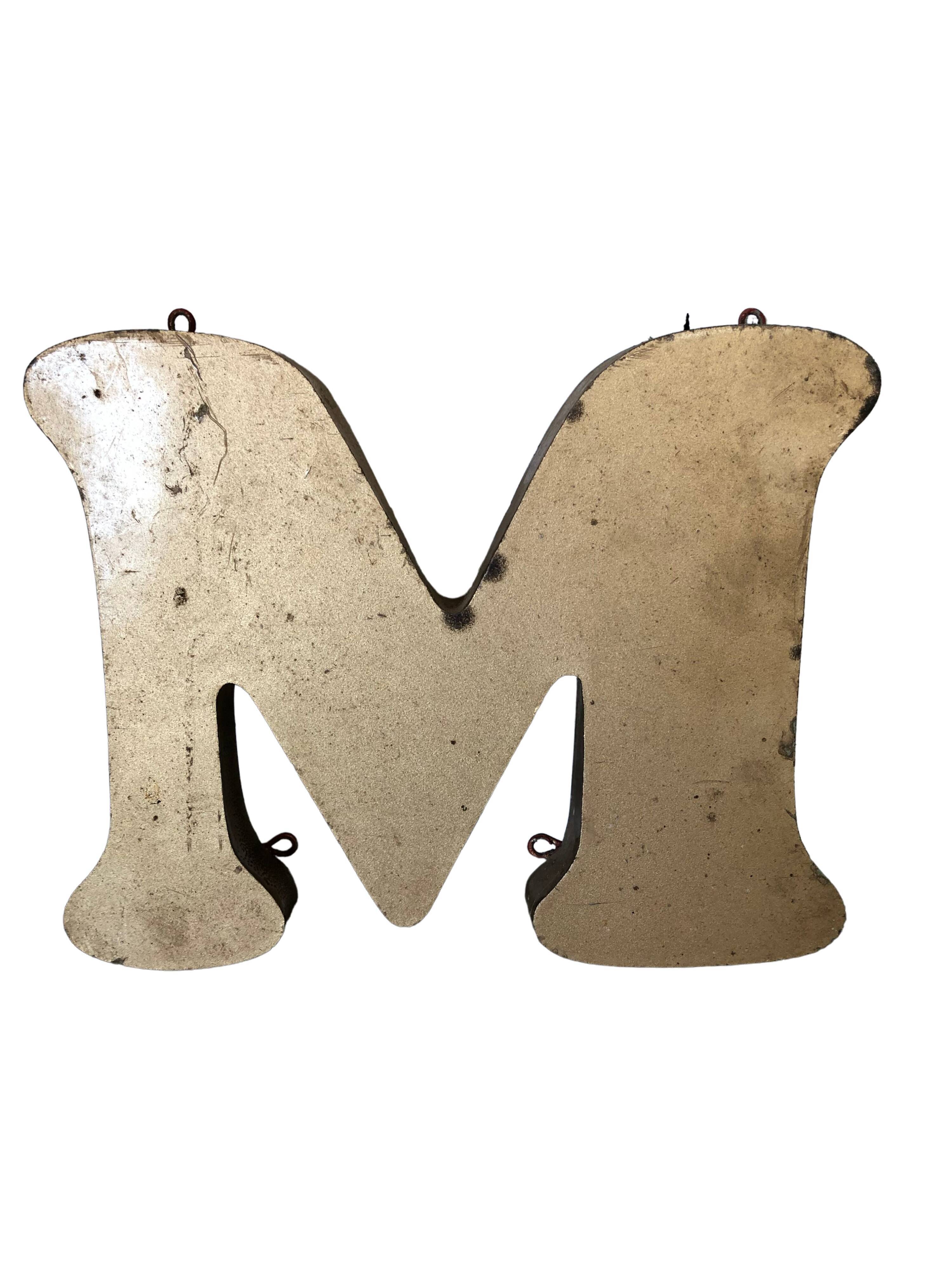 Golden sign letter "M"