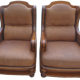 Pair of aged leather armchairs with seat and firm backrest with cherry wood frame