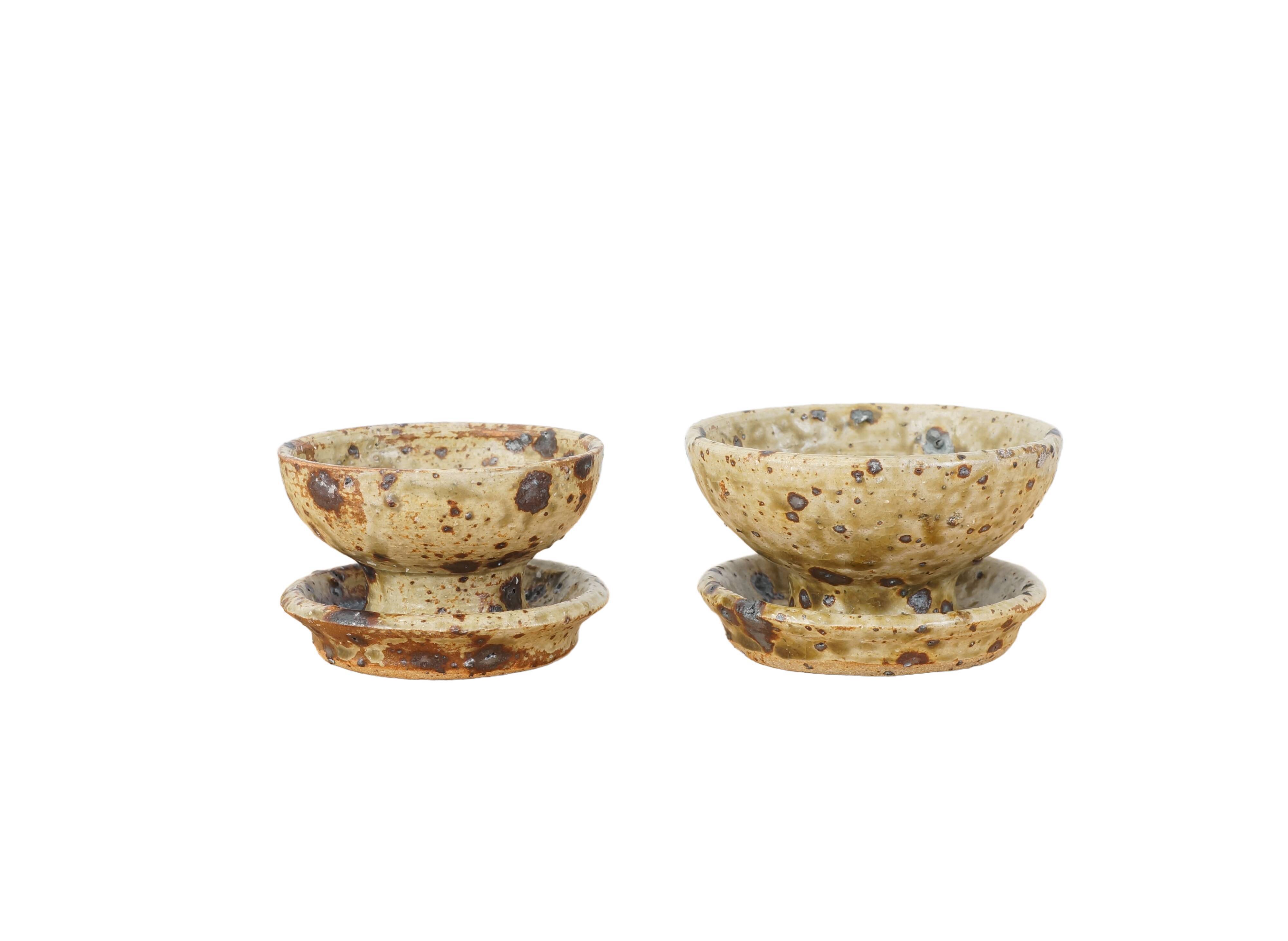 Pair of vergy speckled sandstone candle holders, vintage