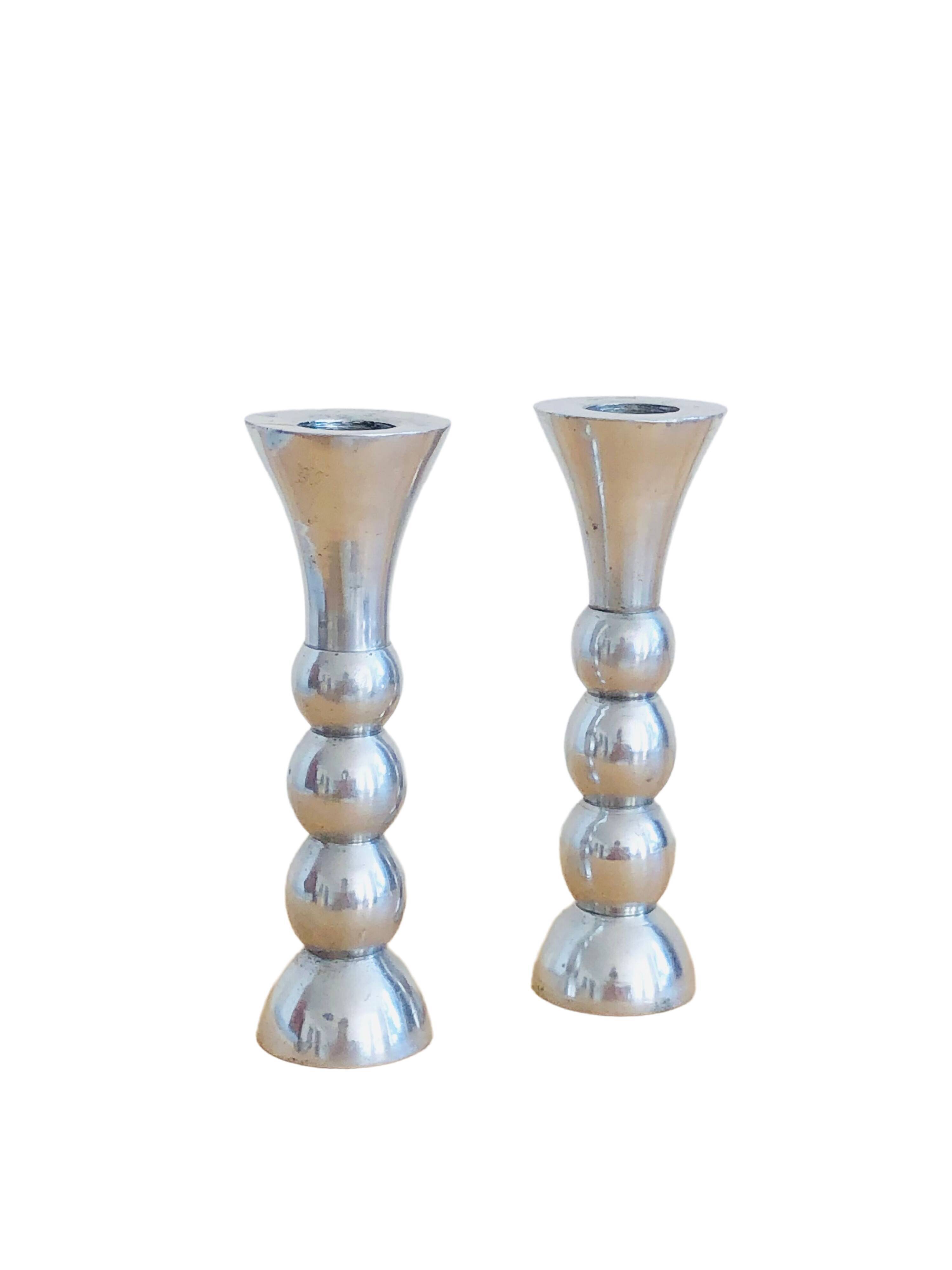 Pair of vintage cast aluminum candle holders