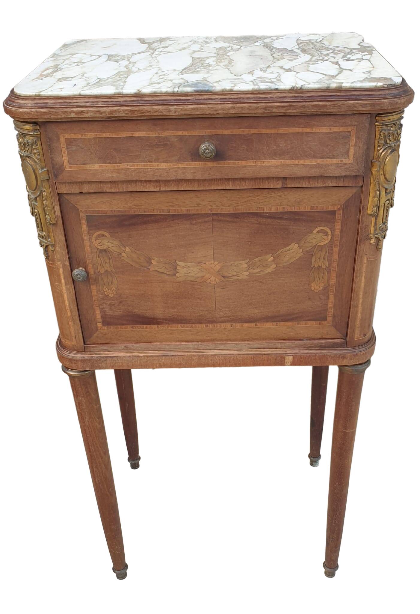 Old wooden bedside table on marble top