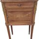 Old wooden bedside table on marble top