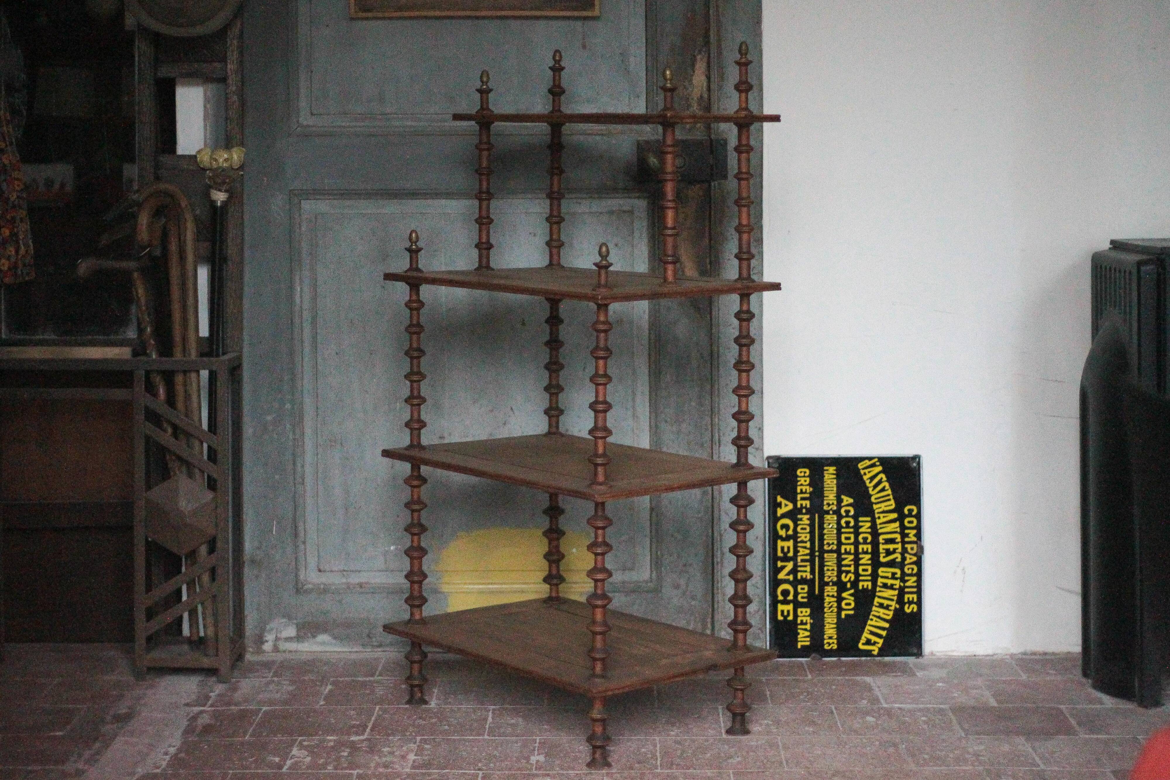 Napoleon III spool shelf, floor-standing shelf with brass tips.