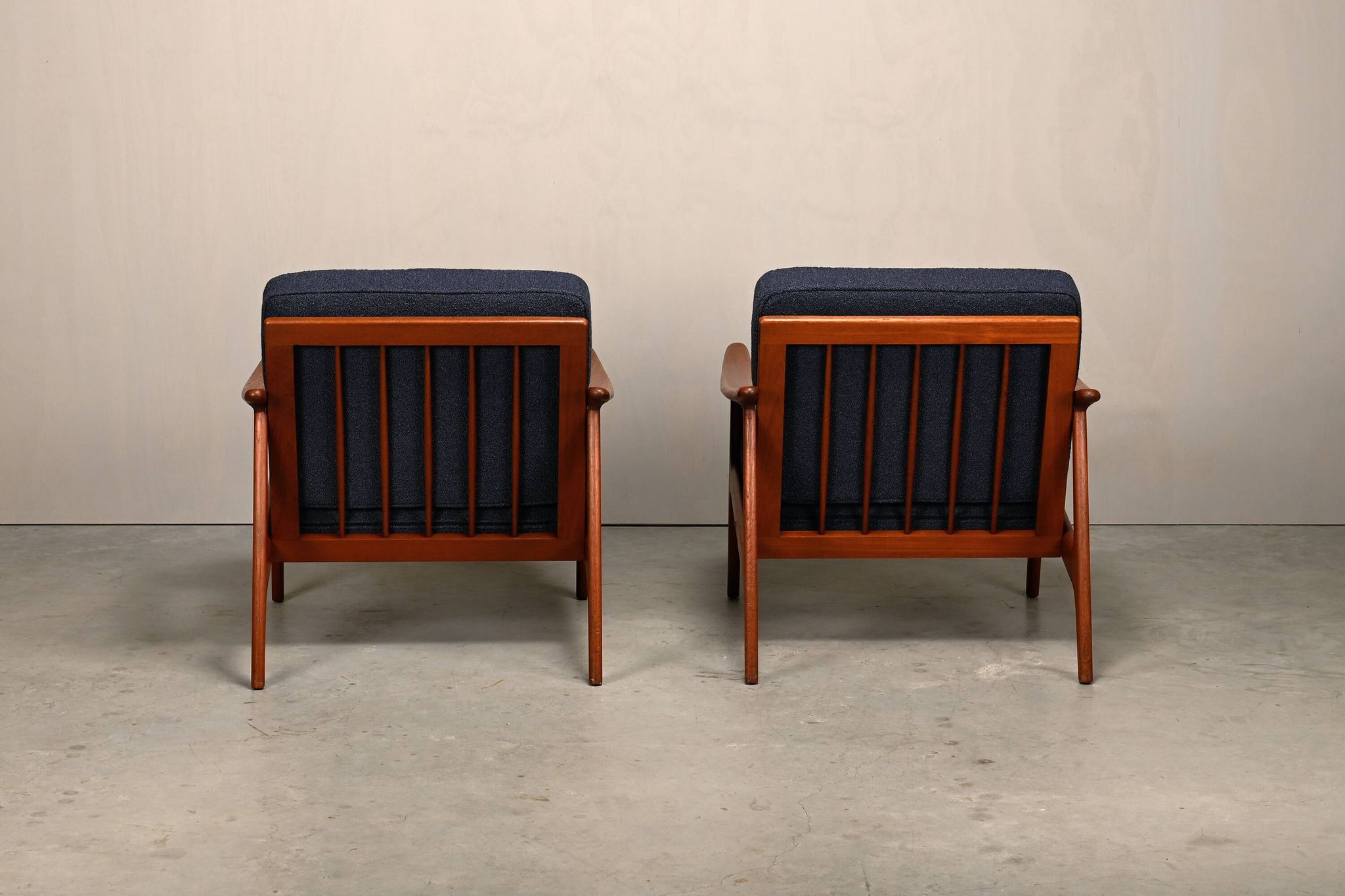 Pair Scandinavian Modern armchairs in teak and dark blue bouclé fabric