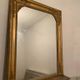 Nineteenth century mirror in wood and stucco gilded with rich gold leaf ornamentation, 101x127 cm