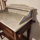 Dressing table in oak wood with a slightly veined white marble top.