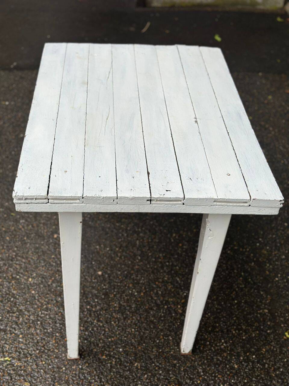 Vintage white wooden kitchen table with drawer from the 19th century.