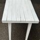 Vintage white wooden kitchen table with drawer from the 19th century.