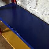 Shelf on multi-colored metal feet