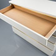 Ivory lacquered furniture and brass in the style of Eric Maville.