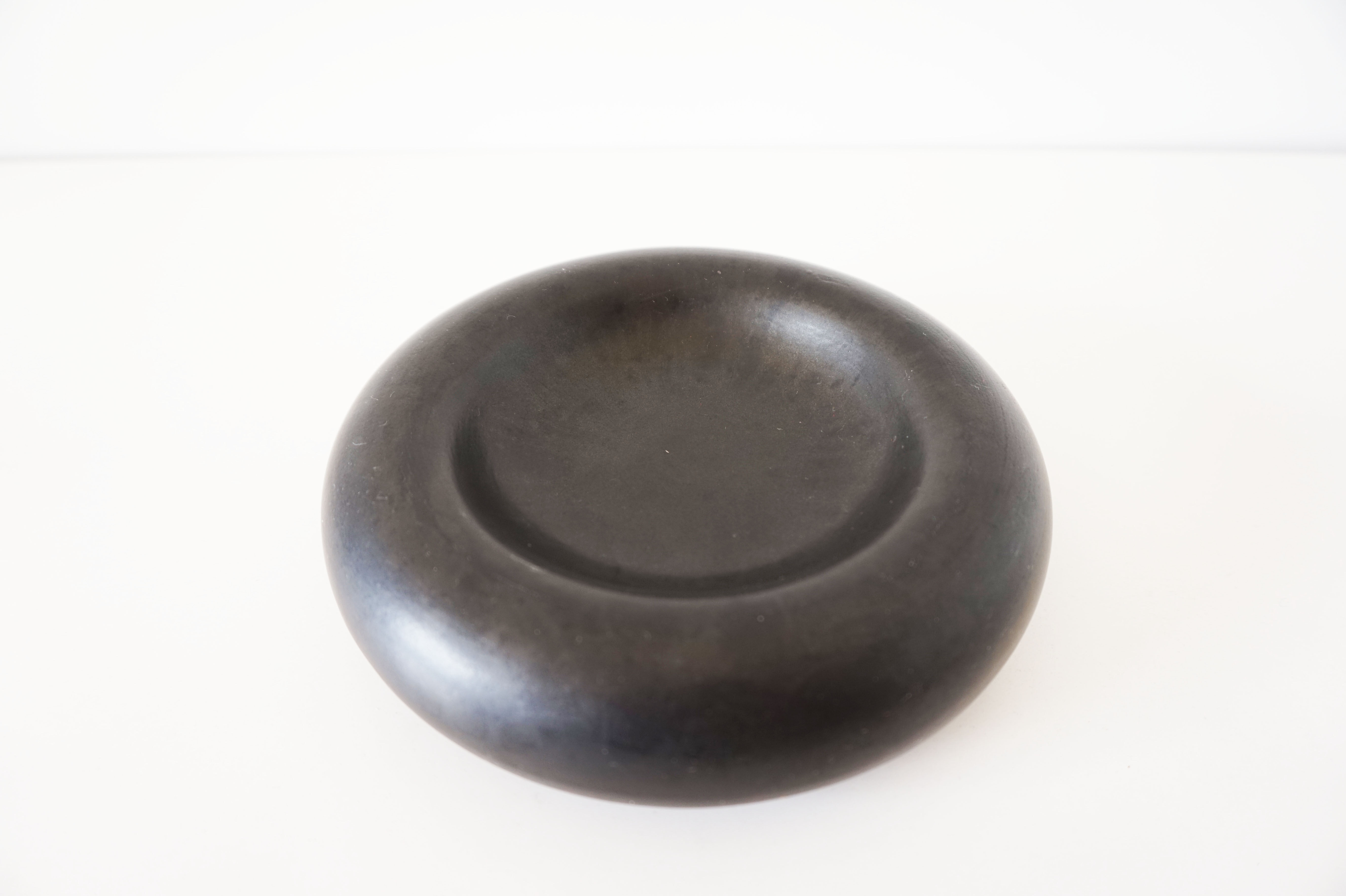 Empty round pocket in black ceramic