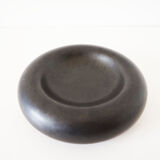 Empty round pocket in black ceramic